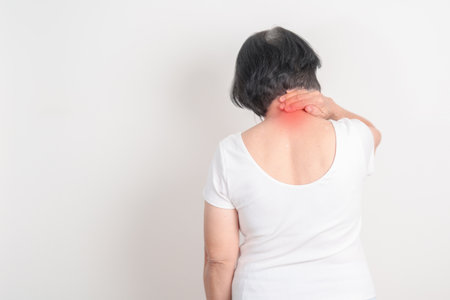 Elderly Woman having Neck pain for concepts of Neck Muscle Strain and Inflammation, Myofascial pain syndrome and Fibromyalgia, Rheumatism, Cervical Spine Spondylosis, Osteoporosis and Health careの写真素材