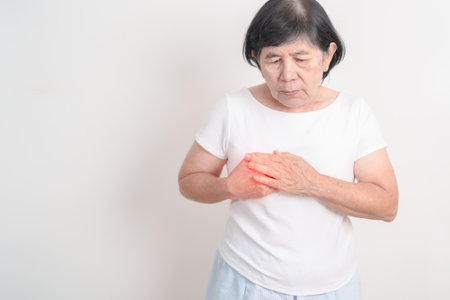 Elderly Woman having Chest pain for concepts of Lung Disease, Lung Cancer, Asthma, Chronic Obstructive Pulmonary or COPD, Bronchitis, Emphysema, Cystic Fibrosis, Bronchiectasis, Pneumonia and Healthの写真素材