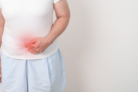Elderly woman having Colon pain for Colonic disease, Inflammatory Bowel, IBD, Colorectal cancer, Ulcerative colitis, Diverticulitis, Irritable bowel syndrome, Digestive system and Health conceptの写真素材