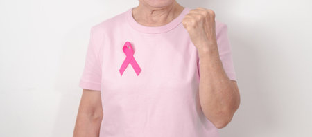 Elderly woman with pink Ribbon for Pink October Breast Cancer Awareness month, May Women Health, August World Breastfeeding week, Nursing Mothers, Pregnancy and Infant Loss Remembrance, Stillbirthの写真素材