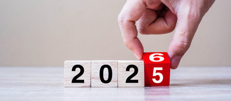 hand flipping block 2025 to 2026 text on table. Resolution, strategy, plan, goal, motivation,...