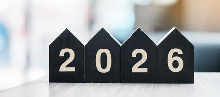 2026 Happy New Year with wooden Home model on table office. New House, Financial, Property insurance and real estate conceptsの写真素材