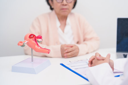 Elderly Woman patient consulting doctor with anatomy Uterus and Ovaries. Ovarian and Cervical...