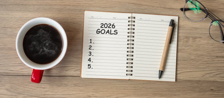 2026 GOAL with notebook, black coffee cup and pen on wood table, Top view and copy space. Happy New Year, Resolution, To do list, Strategy and Plan conceptの写真素材