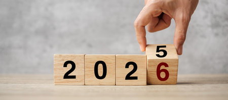 hand flipping block 2025 to 2026  text on table. Resolution, strategy, plan, goal, motivation,...