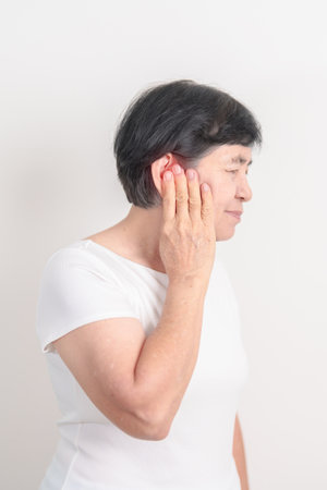 Elderly Woman having Ear pain for concept of Ear disease, Atresia, Otitis Media, Infection,...