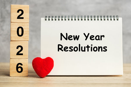 New Year Resolution words and 2026 cubes with red heart shape decoration on table. Goal, plan,...