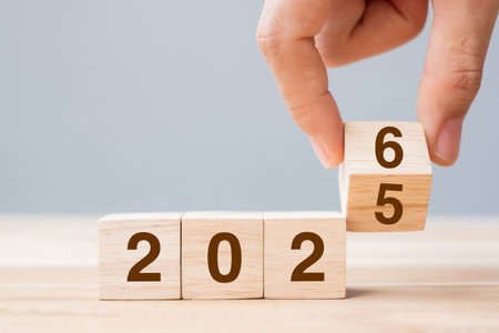 hand flip cube block 2025 to 2026 text on table. Resolution, review, strategy, end year, goal,...