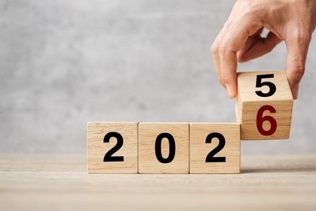 hand flipping block 2025 to 2026  text on table. Resolution, strategy, plan, goal, motivation,...