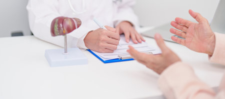 Doctor with human Liver anatomy. Elderly Patient consultation medical health for Liver cancer and Tumor, Jaundice, Viral Hepatitis, Cirrhosis, Failure, Enlarged, Hepatic Encephalopathy, Ascites Fluidの写真素材