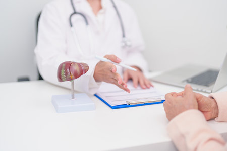 Doctor with human Liver anatomy. Elderly Patient consultation medical health for Liver cancer and Tumor, Jaundice, Viral Hepatitis, Cirrhosis, Failure, Enlarged, Hepatic Encephalopathy, Ascites Fluidの写真素材