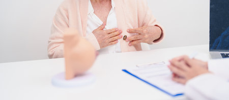 Elderly woman Patient consultation with doctor for Breast Augmentation Surgery, October Breast Cancer Awareness month, implant, Diagnosis, Beauty woman enlargement and medical healthcare conceptの写真素材