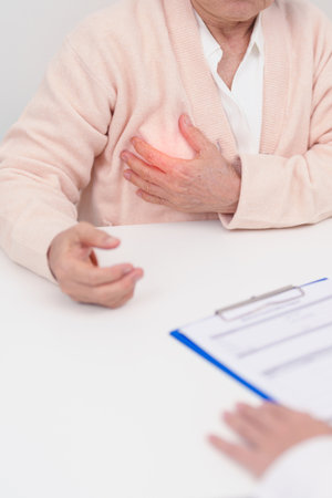 Elderly woman Patient consultation with doctor for Breast Cancer, October Breast Cancer Awareness month, implant, Diagnosis, woman enlargement and medical healthcare conceptの写真素材