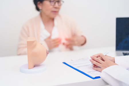Elderly woman Patient consultation with doctor for Breast Augmentation Surgery, October Breast Cancer Awareness month, implant, Diagnosis, Beauty woman enlargement and medical healthcare conceptの写真素材