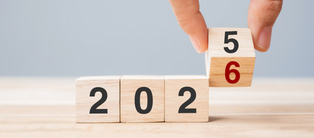 hand flip cube block 2025 to 2026 text on table. Resolution, review, strategy, end year, goal,...