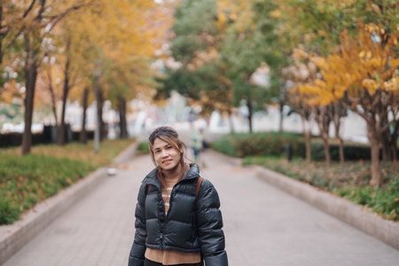 woman traveler visiting in Shanghai, China. Happy Female Tourist sightseeing Shanghai view in The Bund of Shanghai in Autumn season. landmark and popular for tourism attractions. Travel and Vacationの写真素材