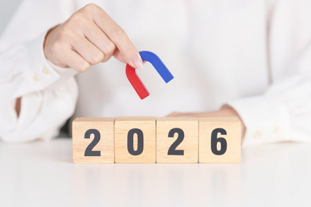 hand holding magnet over 2026 Year block. Human resource management, Recruitment, Teamwork,...