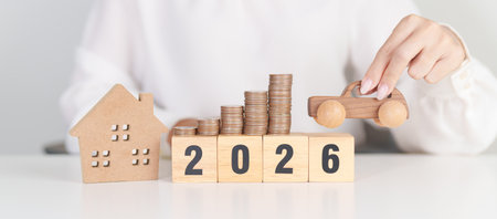 Happy New Year 2026 with car and Home model with coin stack. Car loan, Interest rate, real estate,...
