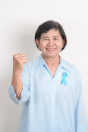 Elderly with blue Ribbon for concept of blue November, November Prostate Cancer Awareness month,...
