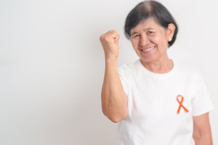Elderly with Orange Ribbon for September Leukemia, March Kidney cancer day, Multiple Sclerosis,...