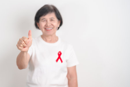 Elderly with Red Ribbon for December World Aids Day, October Red ribbon week, February Heart month,...