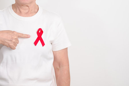 Elderly with Red Ribbon for December World Aids Day, October Red ribbon week, February Heart month,...