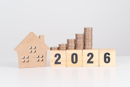 Happy New Year 2026 with house model and Coins stack. real estate, Home loan, tax, investment,...