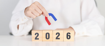 hand holding magnet over 2026 Year block. Human resource management, Recruitment, Teamwork,...