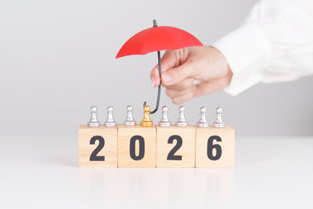 Happy New Year 2026 with hand holding red umbrella cover people chess. life Insurance, health...