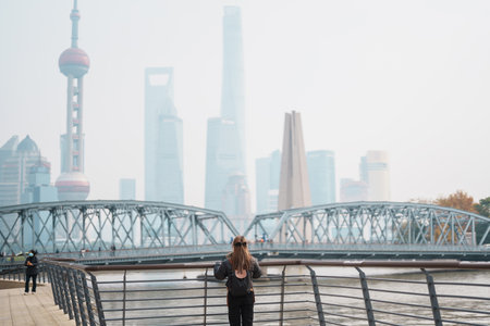 woman traveler visiting in Shanghai, China. Happy Female Tourist sightseeing Oriental Pearl Tower...