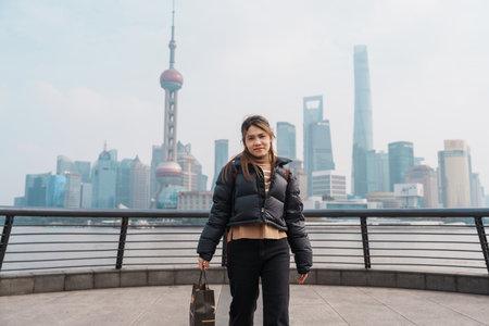 woman traveler visiting in Shanghai, China. Happy Female Tourist sightseeing Shanghai view of...