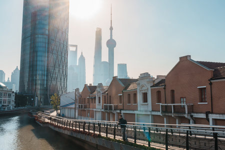 man traveler visiting in Shanghai, China. male Tourist with backpack sightseeing Shanghai view of Lujiazui in Hongkou Gang canal of Shanghai. landmark and popular for tourism attractionの写真素材