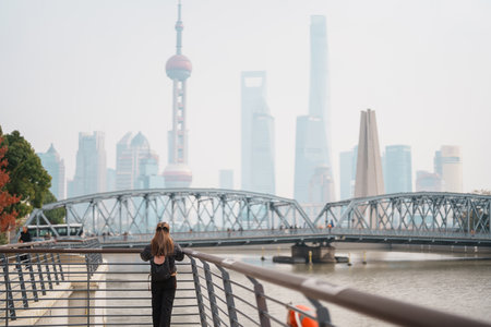 woman traveler visiting in Shanghai, China. Happy Female Tourist sightseeing Oriental Pearl Tower...