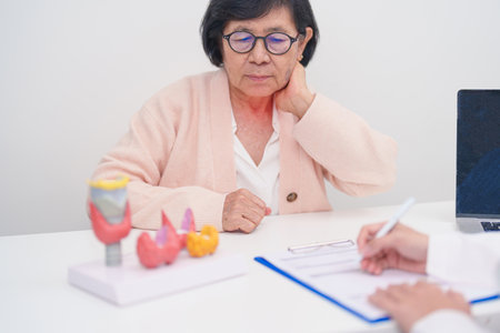 Elderly Patient having Neck pain and consulting with Doctor to Thyroid disease. Anatomy Thyroid...