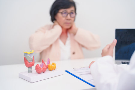 Elderly Patient having Neck pain and consulting  with Doctor to Thyroid disease. Anatomy Thyroid...