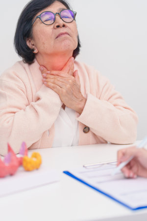 Elderly Patient having Neck pain and consulting  with Doctor to Thyroid disease. Anatomy Thyroid...