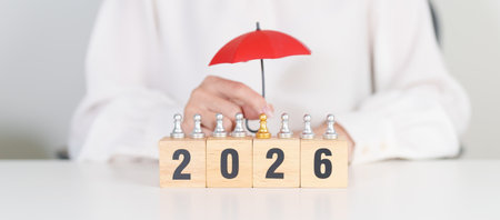 Happy New Year 2026 with hand holding red umbrella cover people chess. life Insurance, health...