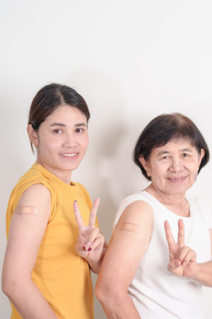 Adult and Elderly Woman with bandage after received vaccine. Vaccination and Immunization for...