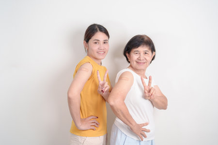 Adult and Elderly Woman with bandage after received vaccine. Vaccination and Immunization for...