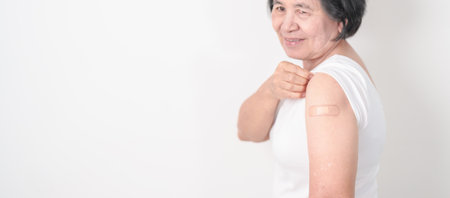 Elderly Woman with bandage after received vaccine. Vaccination and Immunization for Influenza,...