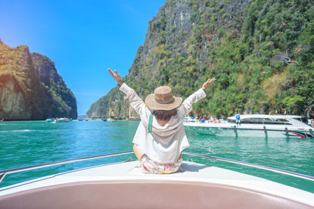 Woman tourist on boat trip, happy traveller relaxing at Pileh lagoon on Phi Phi island, Krabi, Thailand. Exotic landmark, destination Southeast Asia Travel, summer vacation and holiday conceptの写真素材