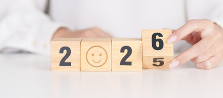 2025 end year to Happy New Year 2026 with Smile block. Satisfaction, feedback, Review, mental health, eco sustainable and good year conceptの写真素材