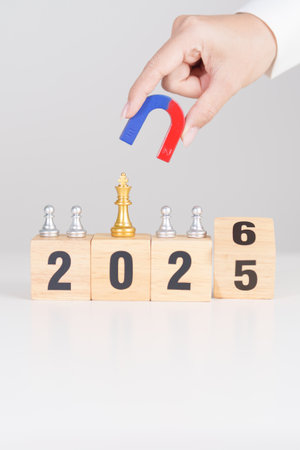 hand holding magnet and pulling man chess figure from the crowd employee with 2026 Year block. Human resource management, Recruitment, Teamwork, strategy, leadership Conceptsの写真素材