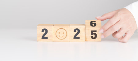 2025 end year to Happy New Year 2026 with Smile block. Satisfaction, feedback, Review, mental health, eco sustainable and good year conceptの写真素材