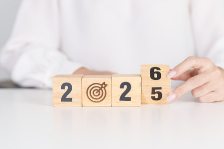 2025 year change to 2026 year block with dartboard icon. Goal, Target, Resolution, strategy, plan, Action, mission, motivation, and New Year start conceptsの写真素材