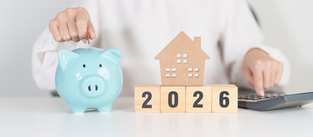 Happy New Year 2026 with house model and Coins stack. real estate, Home loan, tax, investment,...
