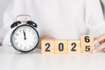 2025 end year to Happy New Year 2026 with vintage alarm clock. Christmas, New Start, Resolution, countdown, Goals, Plan, Action and Motivation Conceptの写真素材