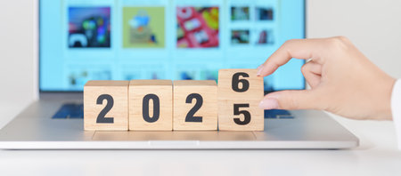 2025 end year to Happy New Year 2026 block against laptop background. Hiring, recruitment, job,...