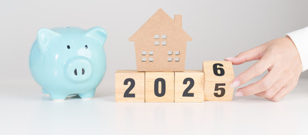 Happy New Year 2026 with house model and Coins stack. real estate, Home loan, tax, investment,...