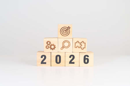 Happy New Year 2026 block with wood block with business goal, strategy, target, mission, action,...